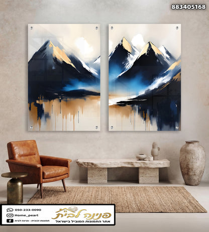 Two-panel glass wall art featuring abstract navy, white, and gold mountains with soft blue reflections, displayed in a modern living room.